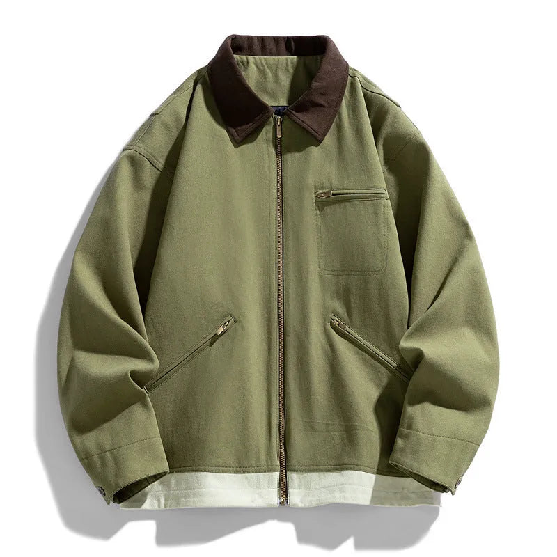 Man wearing a loose-fit mint green casual jacket with dark contrast lapels and side seam pockets.