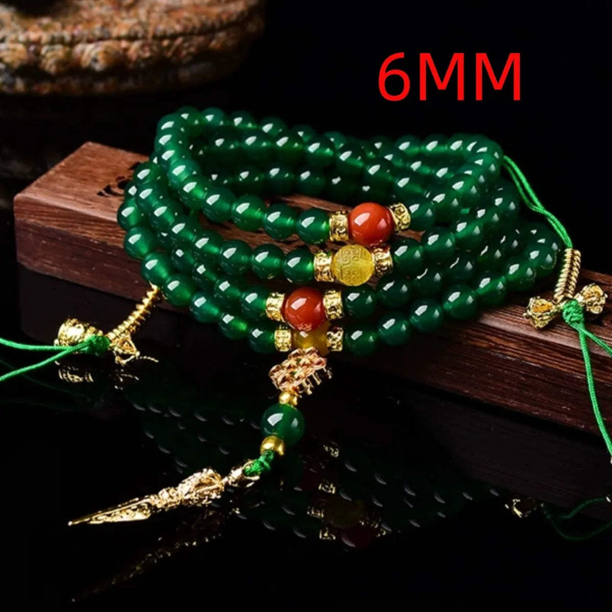 Natural green agate multi-strand bracelet with sliding knot closure on a wrist.
