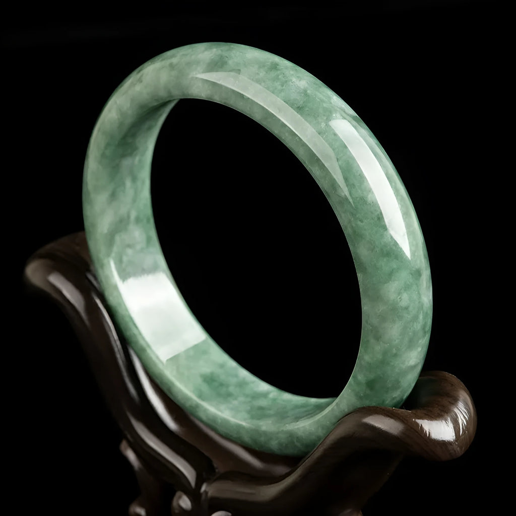 Natural emerald bean green bracelet on wrist, showing simple band and deep green gemstone.
