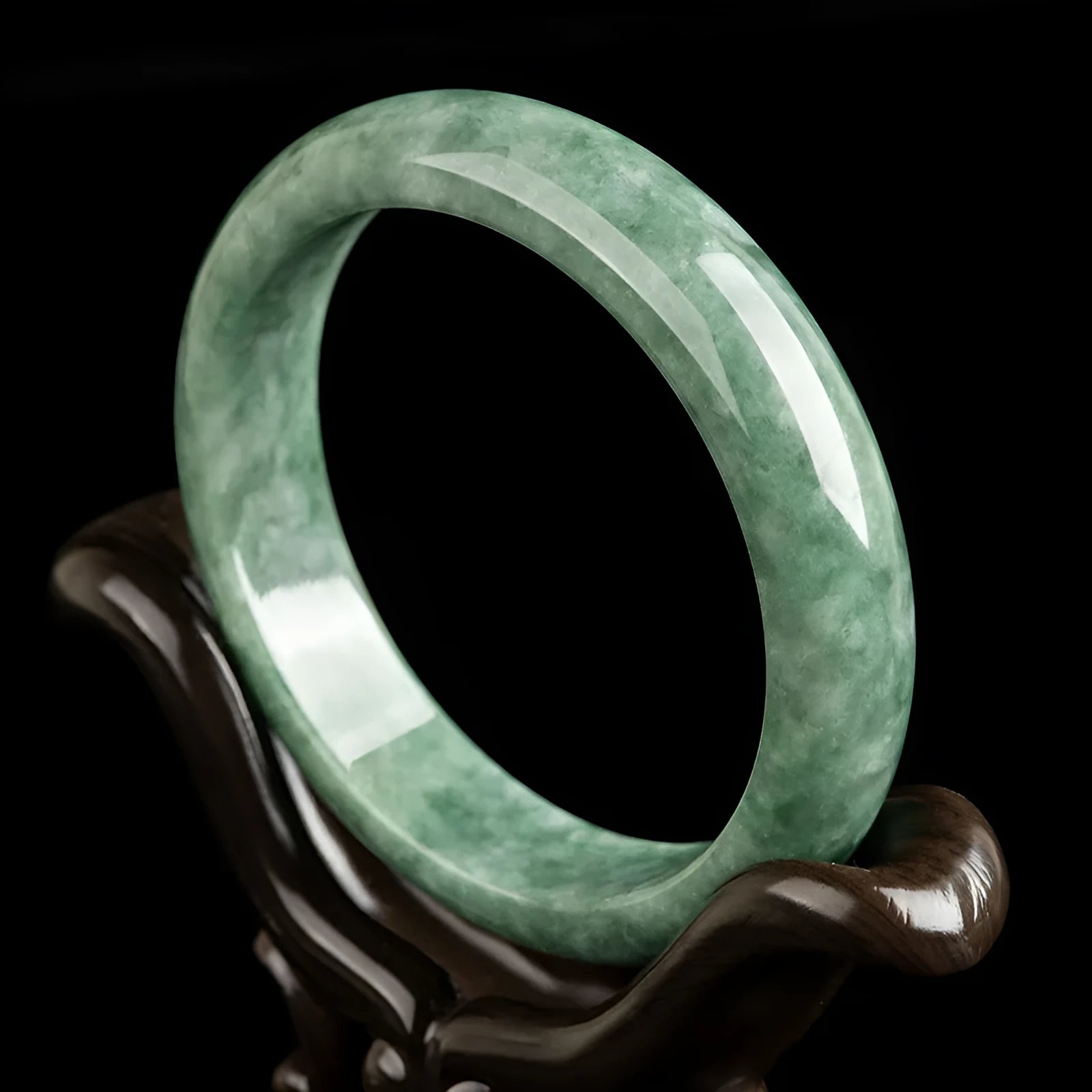 Natural emerald bean green bracelet on wrist, showing simple band and deep green gemstone.