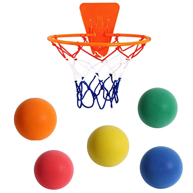 Assorted bright coloured silent high-density foam basketballs in different sizes with a basketball frame.