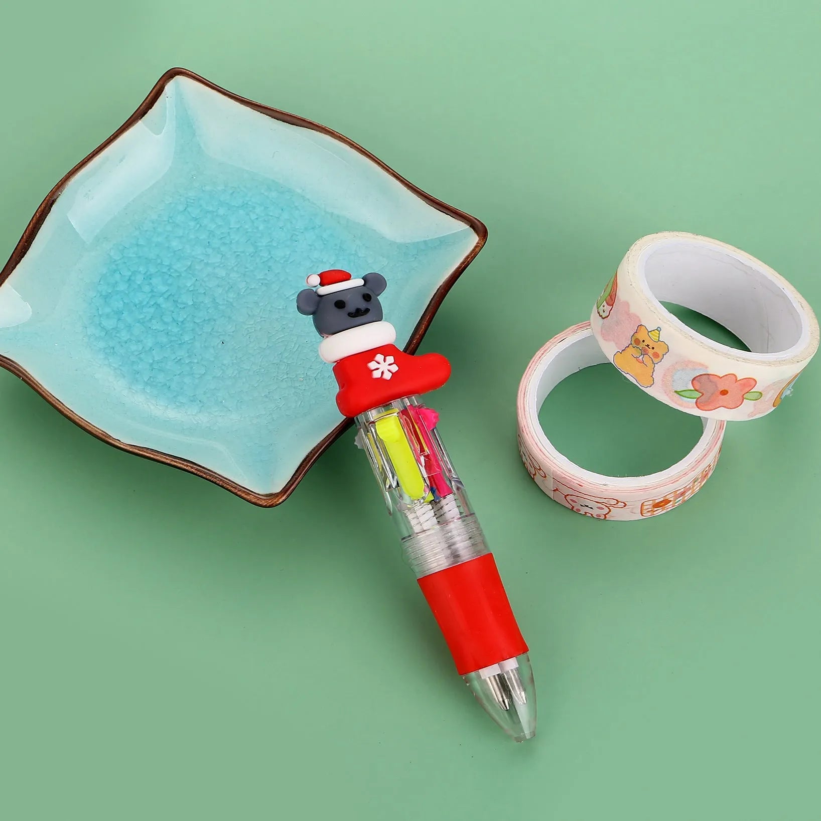Compact 11cm Christmas four-colour press pen with festive designs including reindeer and snowmen.