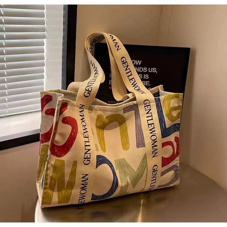 Canvas women's tote bag with printed letter or pattern designs and shoulder straps