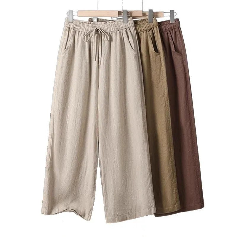 Women's straight leg casual trousers with elastic waist and lace-up drawstring detail in apricot colour.