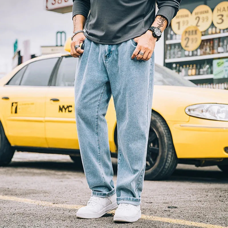 Men's loose straight cotton jeans in dark blue, light blue, and gray with mid-waist zipper fly