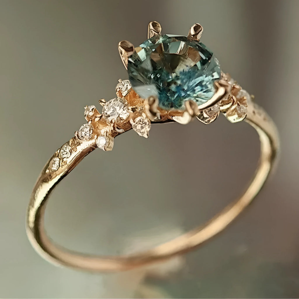 Gold geometric claw ring with square pattern and zircon stones on a grey background.