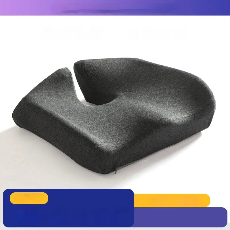 Dark grey memory foam office chair cushion with contoured shape for lower back support on a desk chair.
