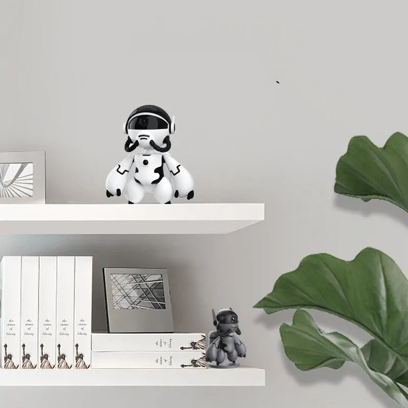 Black or white indoor WiFi security camera with a wide-angle lens on a detachable base.