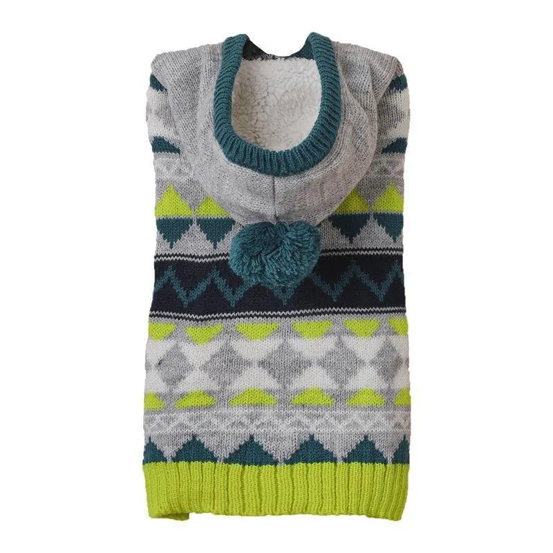 Green diamond pattern knitted acrylic sweater on a small dog, showing ribbed cuffs and classic knit design.