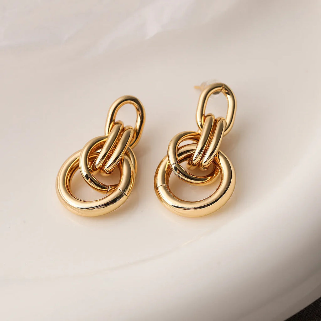 Gold geometric copper earrings with irregular shape and simple pierced design