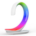 White swan wireless charging Bluetooth speaker with colourful ambient lighting on desktop