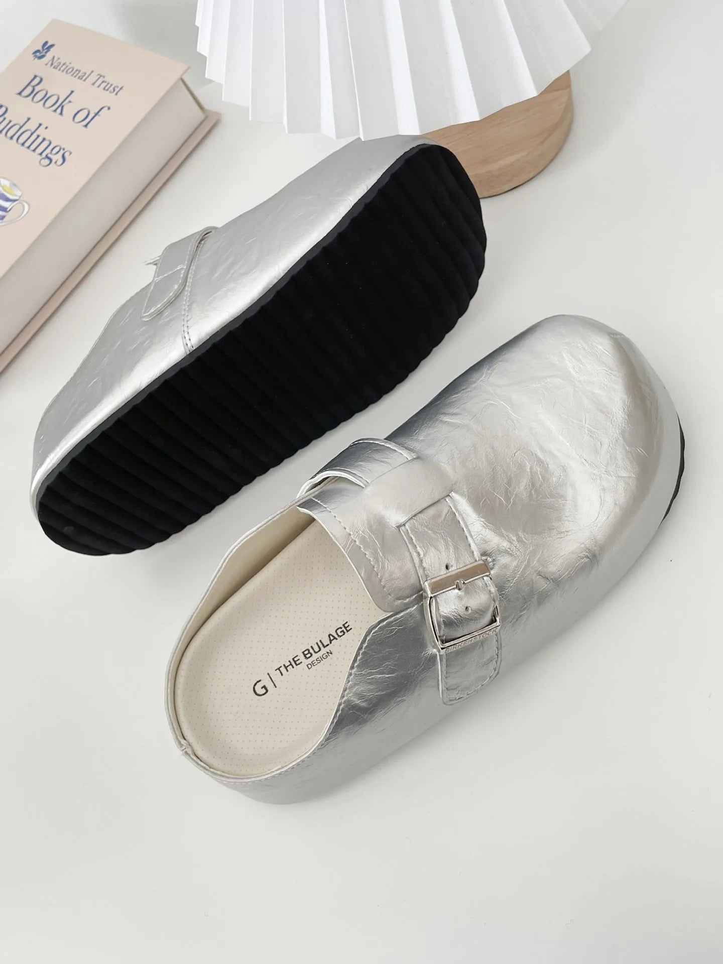 Flat buckle casual sneakers in yellow, black, silver, and creamy-white colours with rounded toe shape
