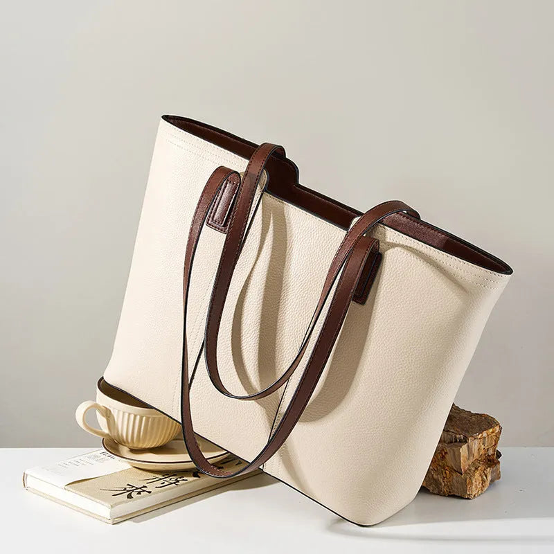 Women's black horizontal square leather commuter shoulder bag with crossbody strap and internal organiser pockets.
