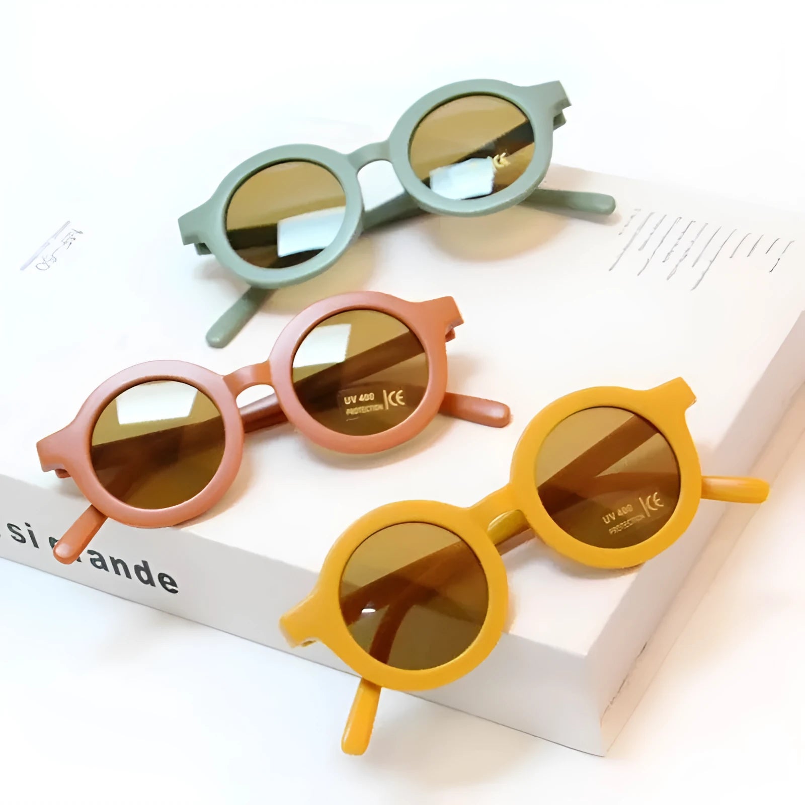 Children round frame retro mocha glasses on a child, showing the PC frame and resin lenses available in Beige, Brown, Green, Orange Red, Orange Yellow, Pink, and Purple colours