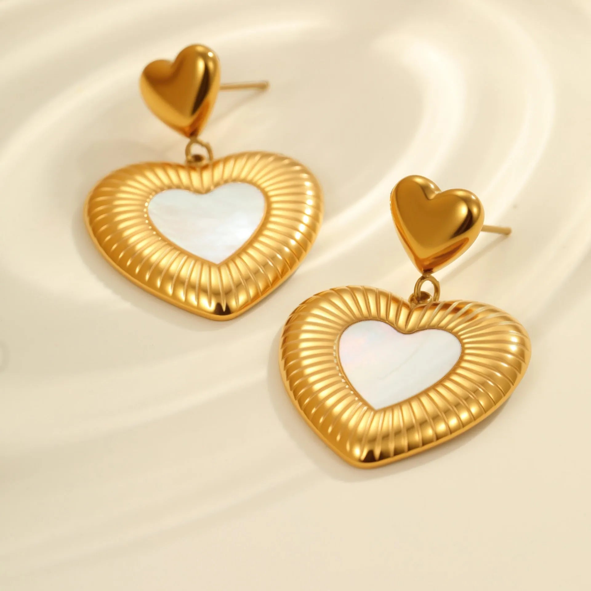 Heart-shaped stainless steel women's earrings with gold electroplated finish and love motifs