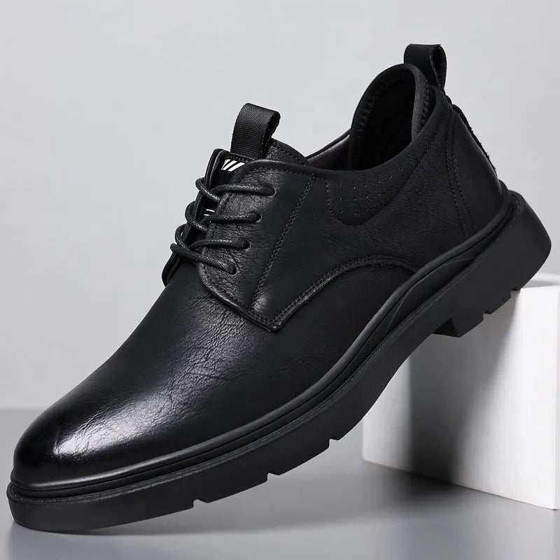 Men's black and brown leather casual sneakers with sewing line detail on the upper.