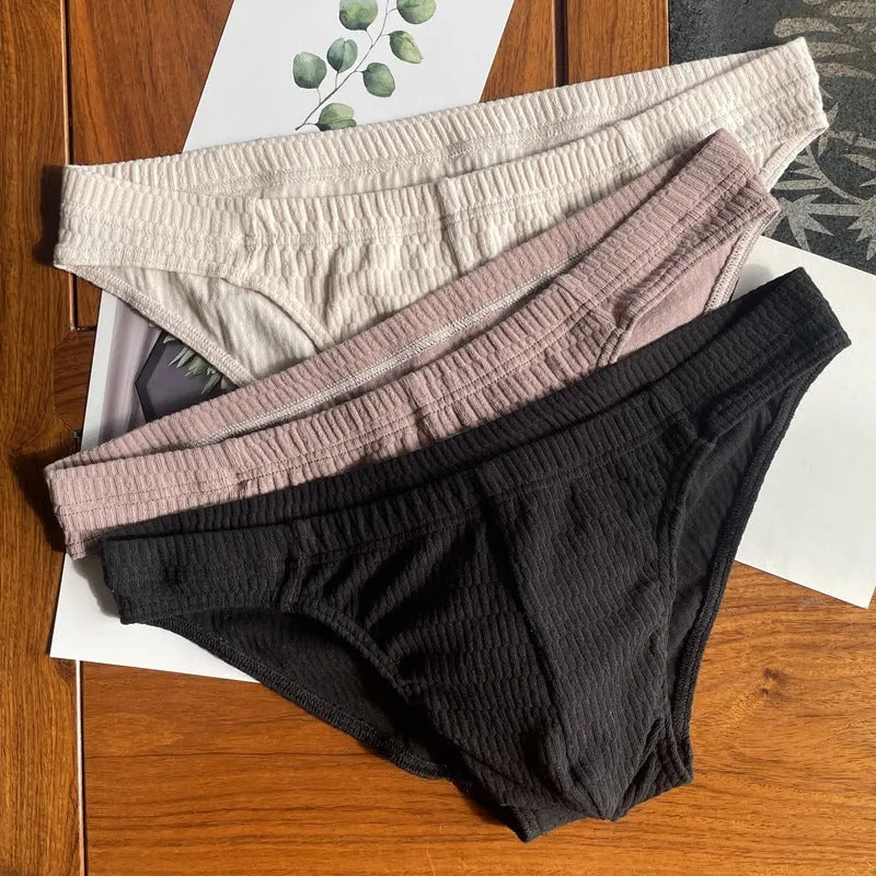 Men's solid colour cotton briefs with a mid waist and triangle design.
