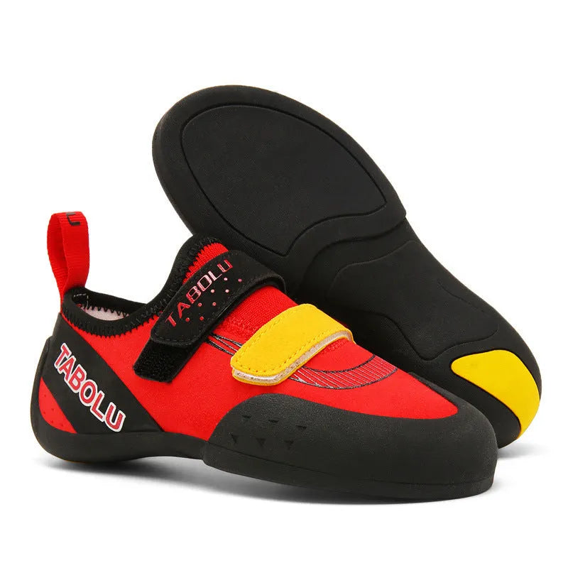 Pair of beginner rock climbing shoes with Velcro strap and black and red rubber outsole.