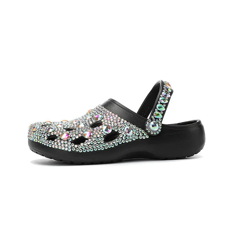 Black women's platform sandals covered in rhinestones with a chunky EVA sole.
