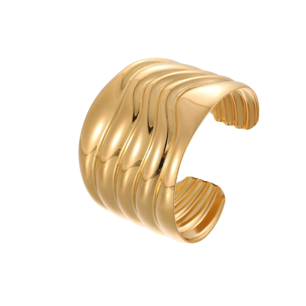 Women's exaggerated wide stainless steel bracelet with geometric wave design and niche opening in gold finish