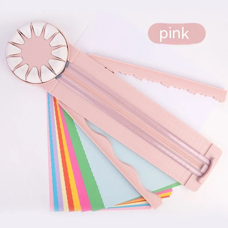 Pink 12-in-1 dotted line paper cutting machine on desktop for card making and scrapbooking