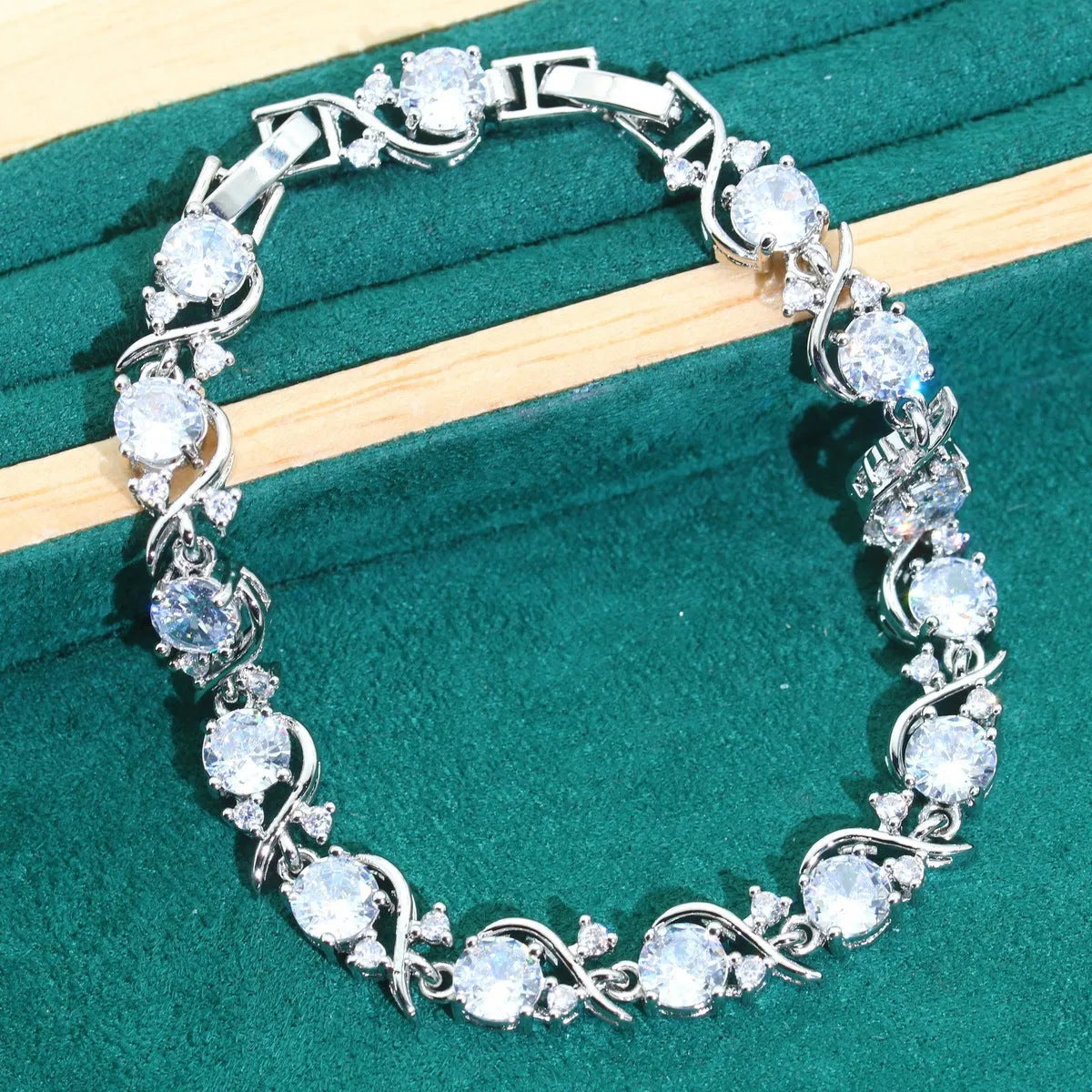 Four-piece bridal jewellery set showing necklace, earrings, ring, and bracelet with alloy pendant and water wave chain