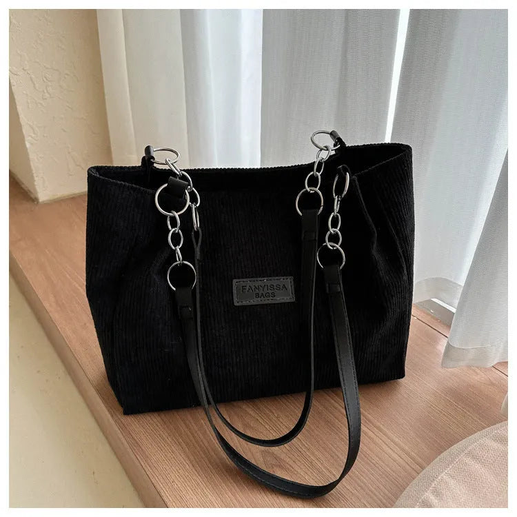 Corduroy one-shoulder tote handbag in a horizontal square shape, shown in brown colour.