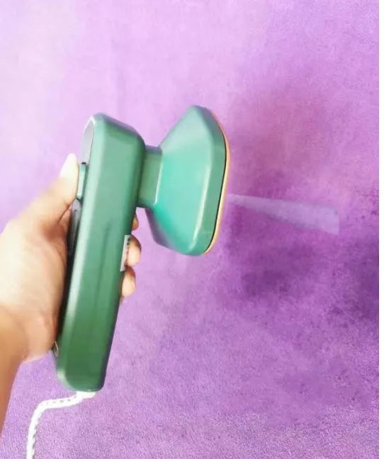 Dark green portable hanging steam iron machine with ceramic panel and compact design.