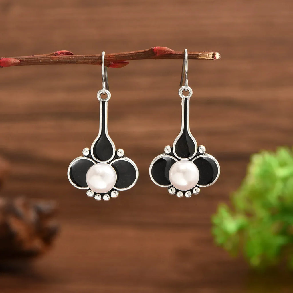 A pair of silver retro fashion earrings for women with an electroplated alloy construction.