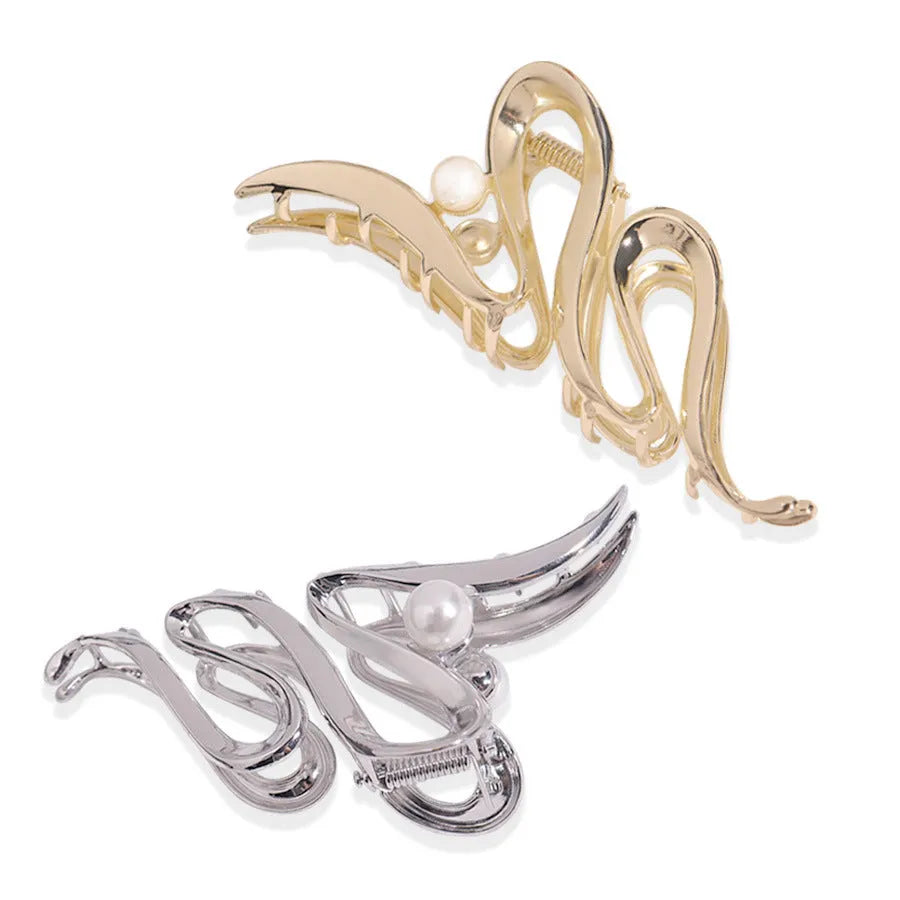 Assortment of silver metal hair claw barrettes with various designs including bows, pearls, and geometric shapes.