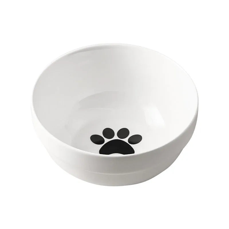 White ceramic pet bowl with cat paw design on a black metal stand with cat ear details.