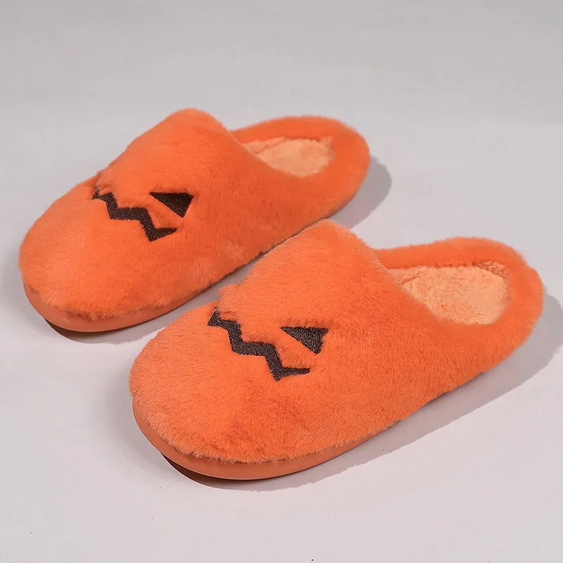 Orange women's pumpkin-themed plush slippers with a coral velvet upper and a flat non-slip sole.