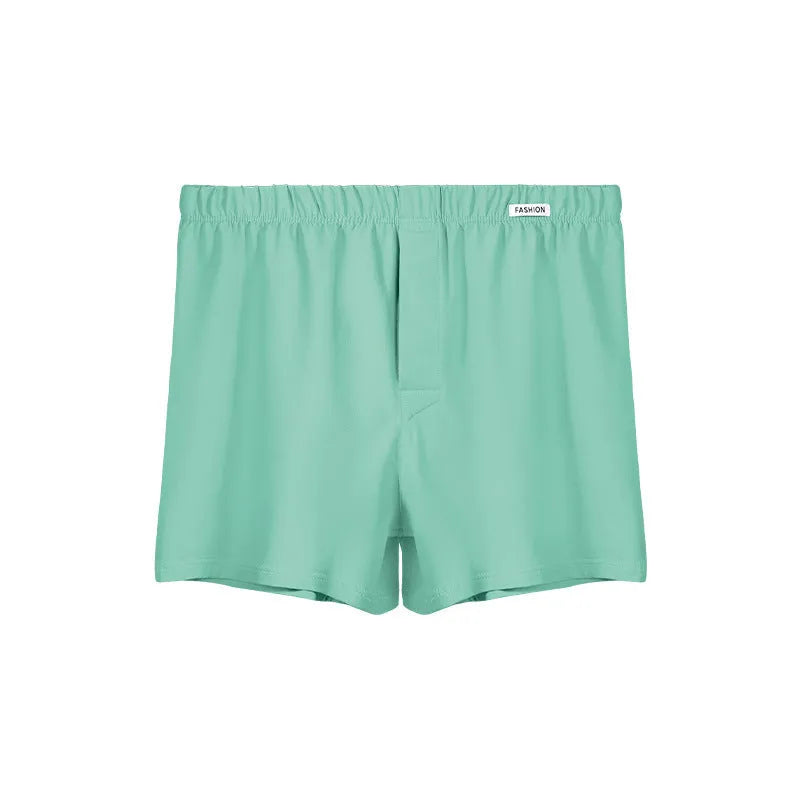 Men's loose-fitting cotton boxer shorts in a solid colour, shown in a light grey shade on a mid waist.