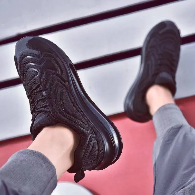 Men's black casual sneakers with lace-up front, thick sole, and round toe design