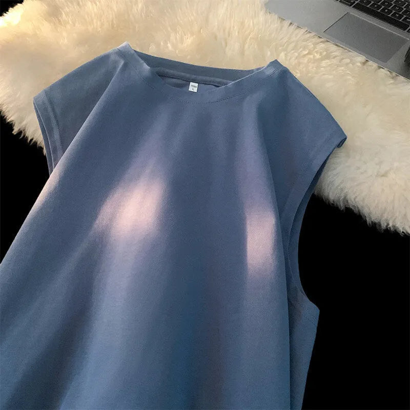 Men's solid colour loose fit cotton tank top on a hanger, showing straight hem and sleeveless design.