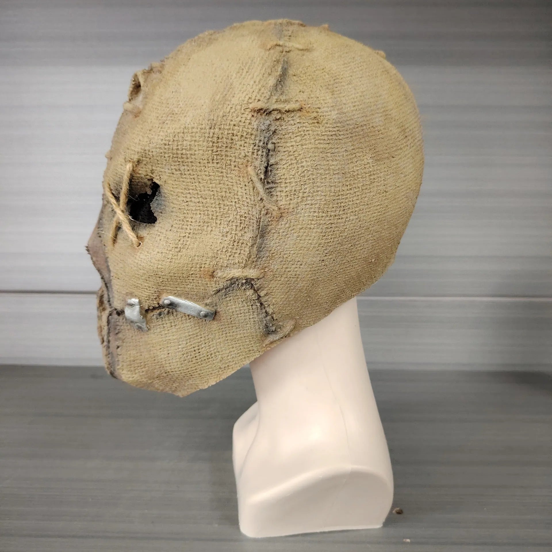 Latex Halloween horror mask showing detailed scarred skull modelling