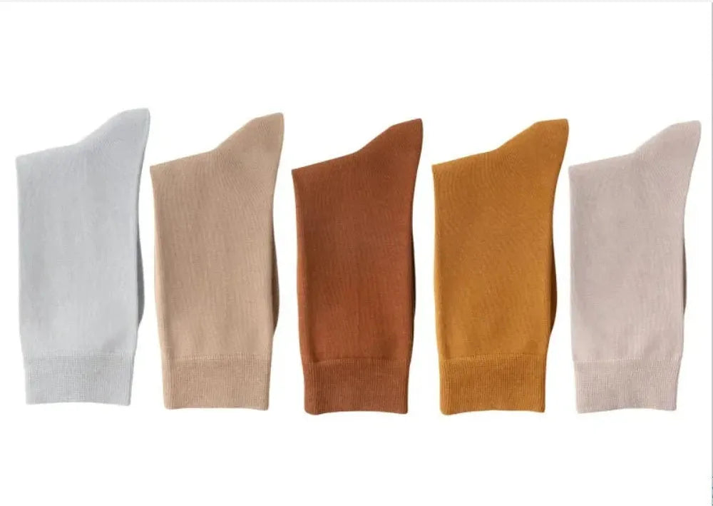Mid-calf men's socks in solid colours made from combed cotton, shown in a stack.