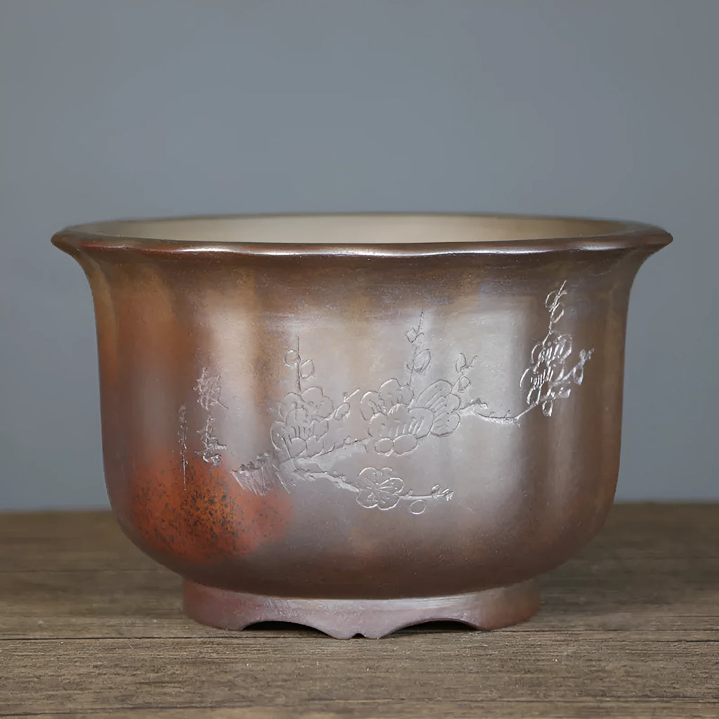Indoor antique carved ceramic flower pot in purple sand clay with old pile texture