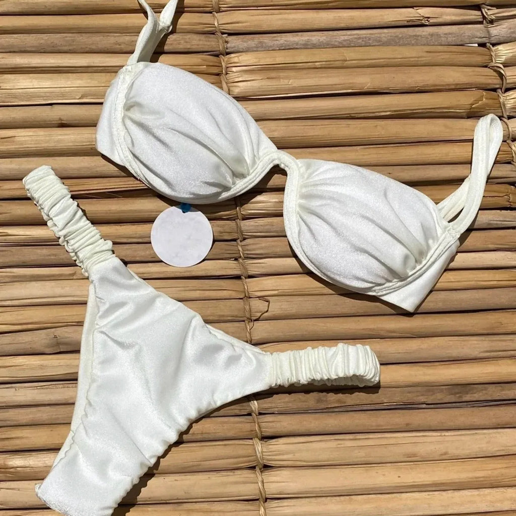 Women's black underwire bikini top and briefs set on a mannequin, showing sleeveless design.