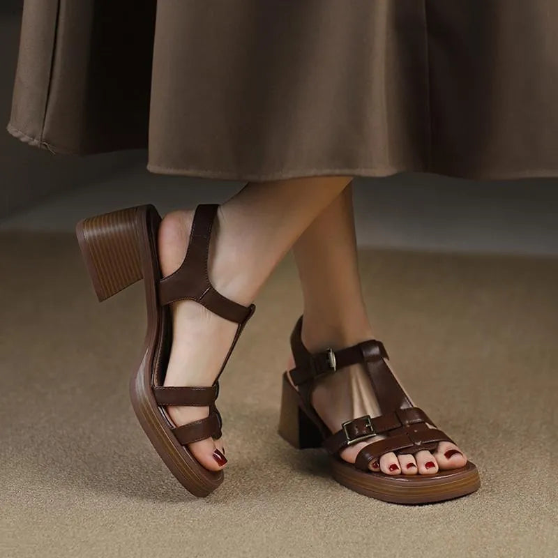 Black women's retro platform sandals with a T-buckle strap and chunky heel.