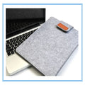 Dark grey clamshell laptop bag open to show interior laptop compartment and corner protector.