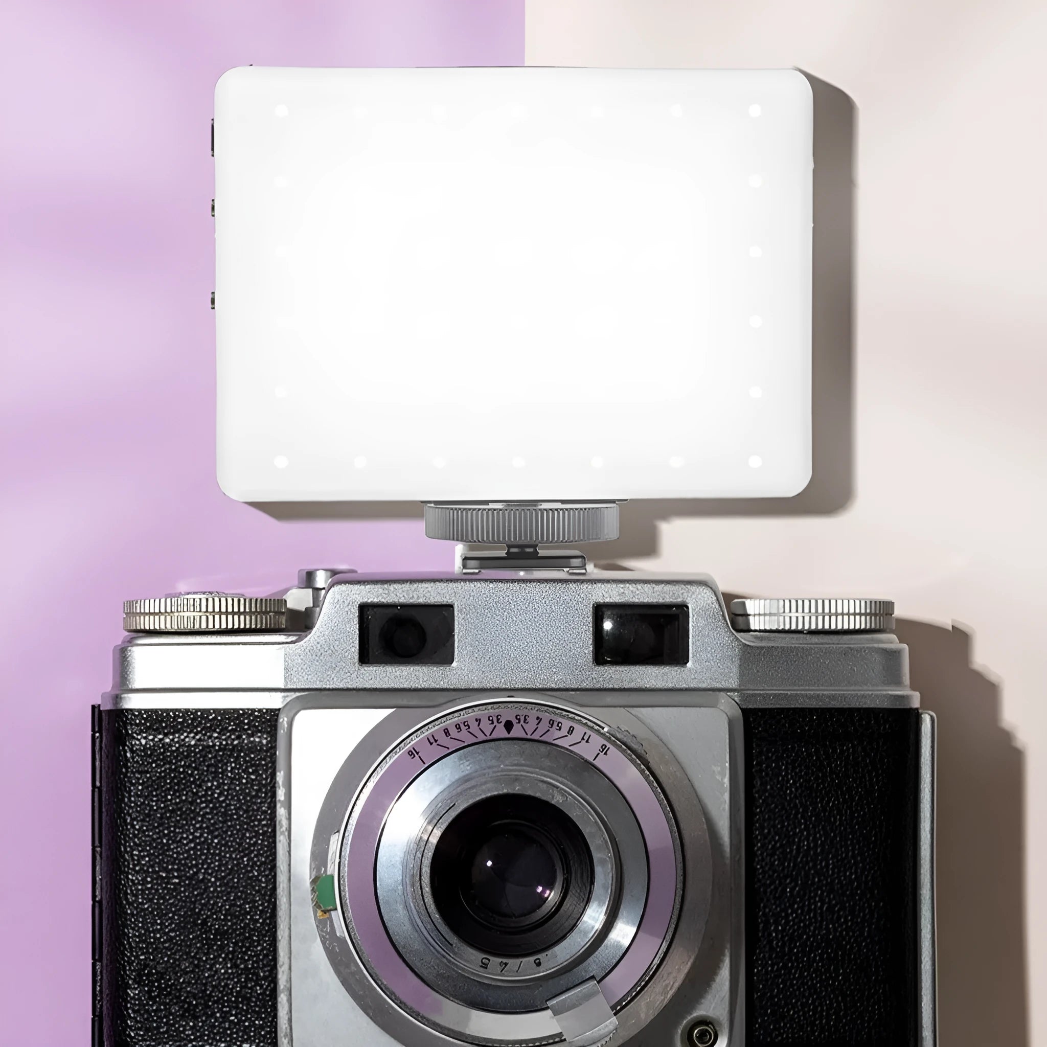 Handheld pocket LED fill light with clip attached to a smartphone for video lighting.