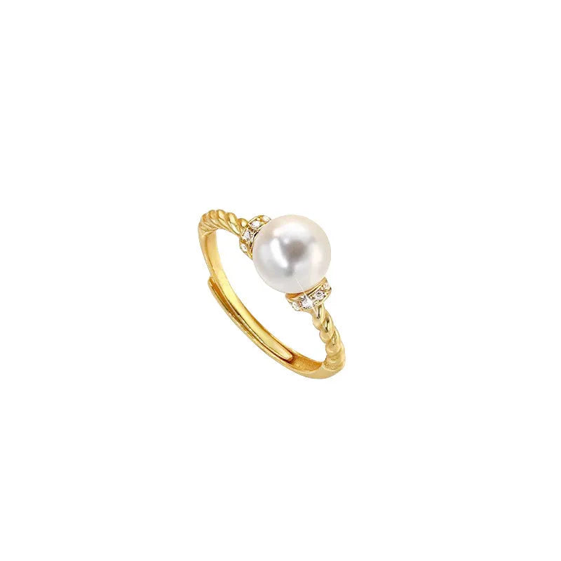 Adjustable antique twist ring with a pearl inlay, shown in gold and silver copper finish.
