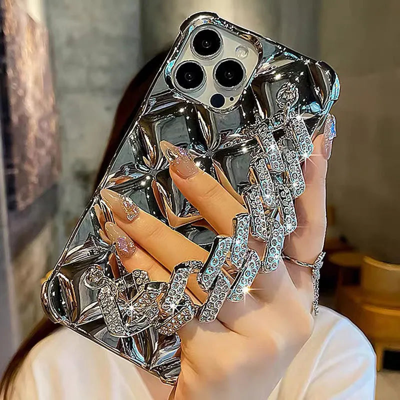 Silver and gold luxury diamond bracelet iPhone cases with chain strap and lock charm for various models.