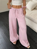 Women's black wide leg trousers with lace-up waist detail showing adjustable fit feature