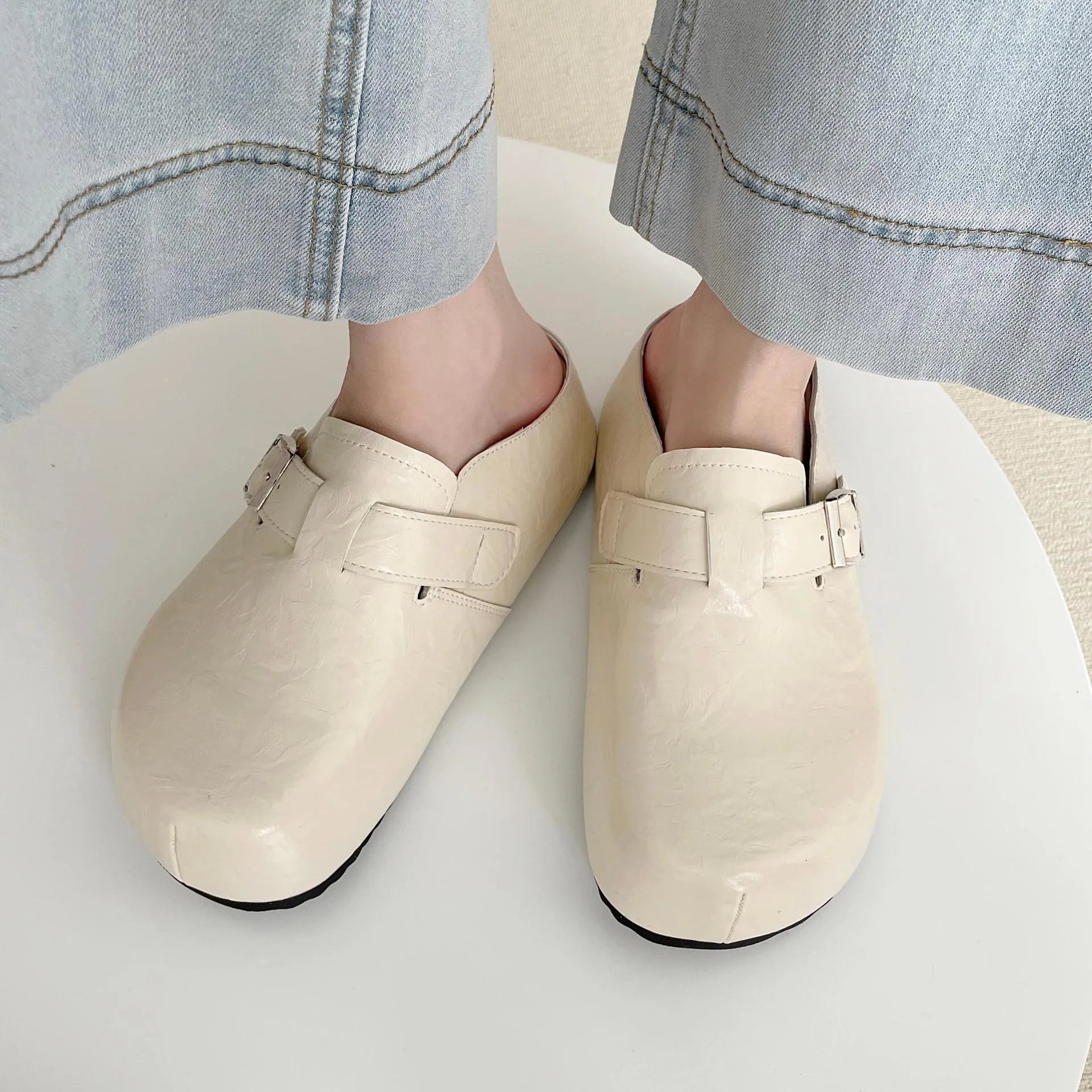 Flat buckle casual sneakers in yellow, black, silver, and creamy-white colours with rounded toe shape