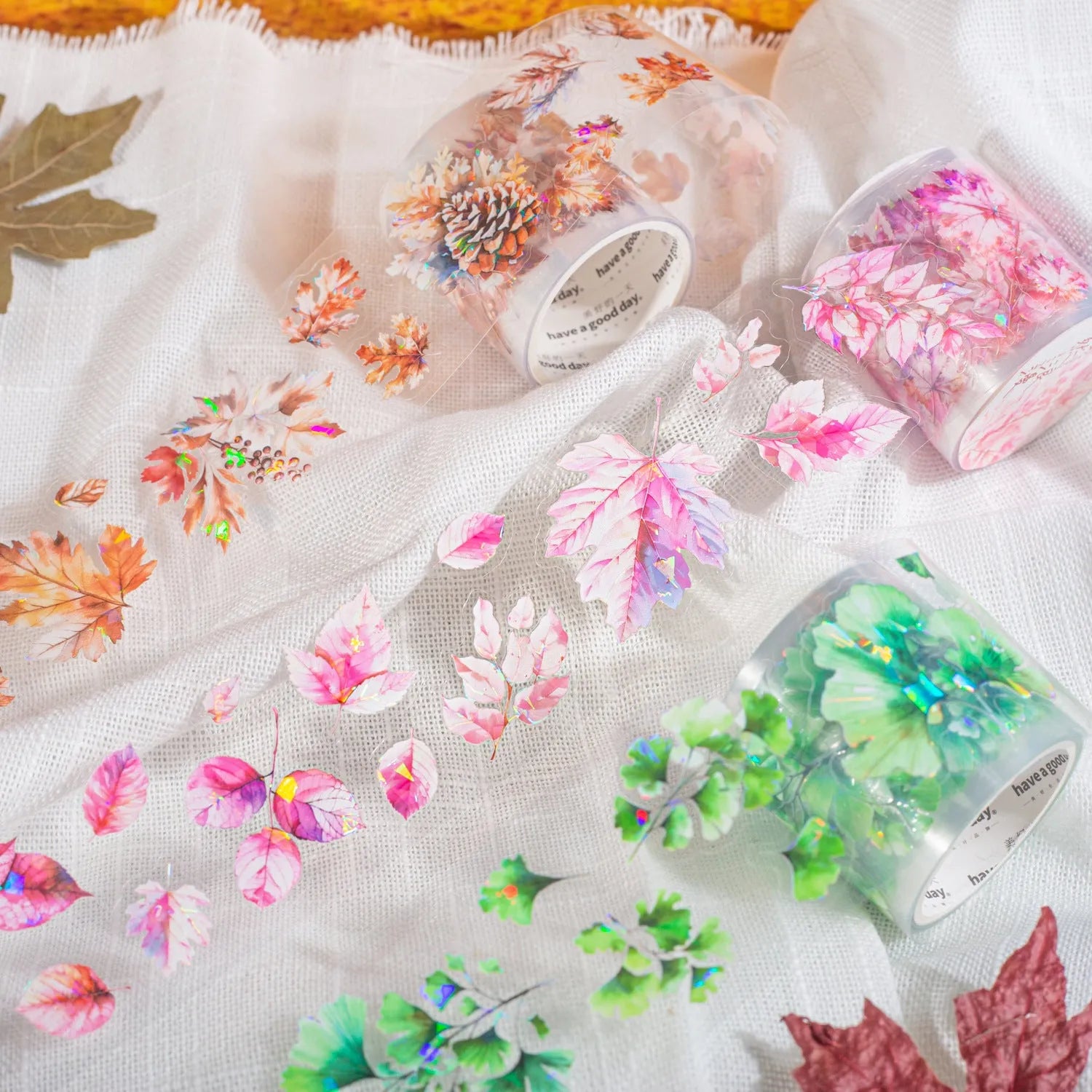 Six rolls of nature-themed decorative stickers showing gentle ginkgo, maple leaf, and blue fallen leaves designs.