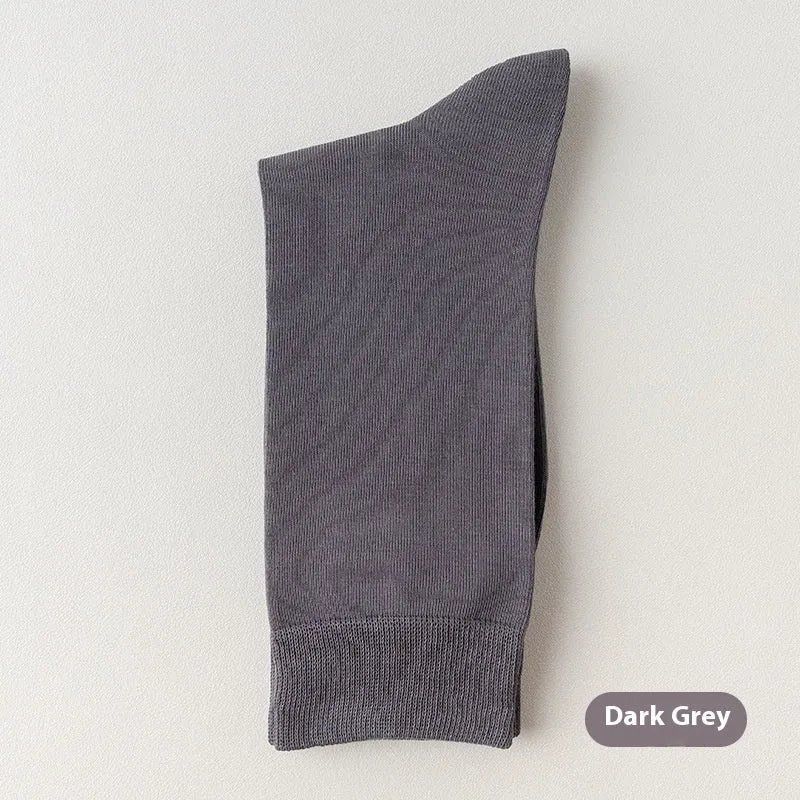 Mid-calf men's socks in solid colours made from combed cotton, shown in a stack.