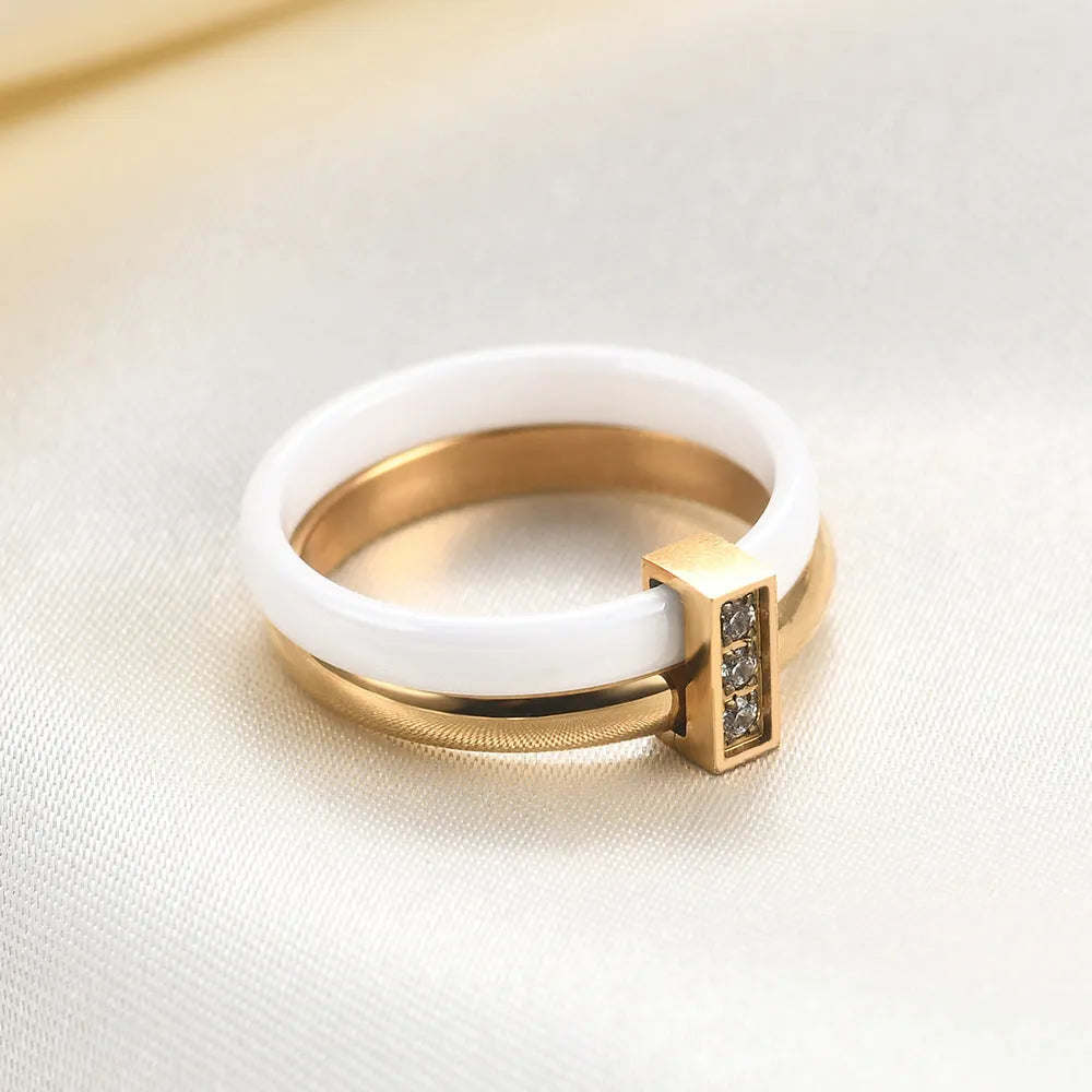 Women's geometric ceramic ring with glossy stitching and inlaid zirconium, in steel black or gold white.