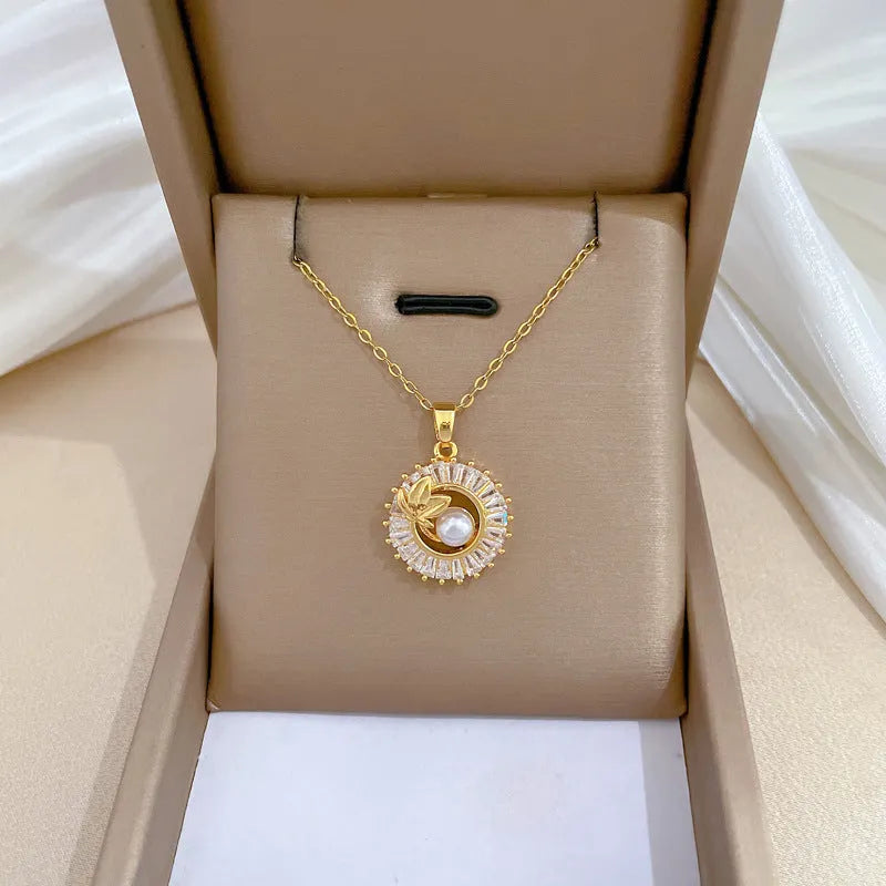 Women's geometric jewellery set showing necklace and earrings with ring and leaf designs in gold and silver tones
